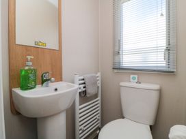 A bathroom with a sink and toilet at 14 Pines in Cayton Bay