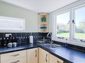 A kitchen with a sink and kettle at Farthing Cottage in Corfe Castle