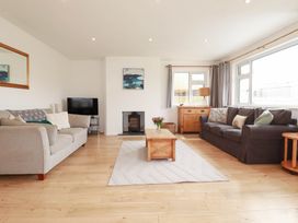 A living room with a sofa and a coffee table at Cloudbreak in Wadebridge