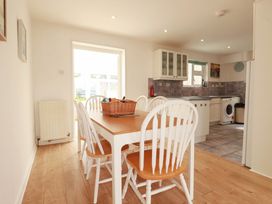 A dining room with a table and chairs at Cloudbreak in Wadebridge