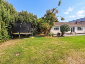 A garden with a trampoline and seating area at Cloudbreak in Wadebridge