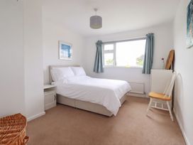 A bedroom with a bed and side table at Cloudbreak in Wadebridge