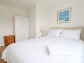 A bedroom with a bed and wardrobe at Cloudbreak in Wadebridge