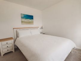A bedroom with a bed and nightstand at Cloudbreak in Wadebridge
