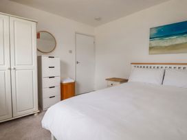 A bedroom with a bed and wardrobe at Cloudbreak in Wadebridge