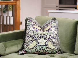 A cushion on a green sofa at 14 Brunswick Street Whitby