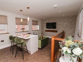 A living room with a sofa and table at 14 Brunswick Street, Whitby