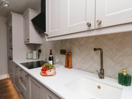 A kitchen with a sink, cooktop, and cutting board at 14 Brunswick Street Whitby