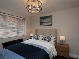 A bedroom with a bed, bedside table, and window at 14 Brunswick Street Whitby