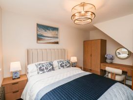 A bedroom with a bed and a dressing table at 14 Brunswick Street Whitby