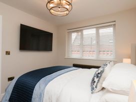 A bedroom with a bed and television at 14 Brunswick Street, Whitby