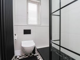 A bathroom with a toilet and shower at 14 Brunswick Street in Whitby