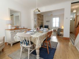 A dining room with a table set for a meal at 57 High Street in Portland