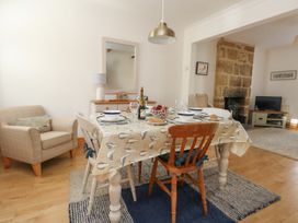 A dining room with a table set for a meal at 57 High Street in Portland