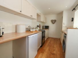 A kitchen with cabinets and appliances at 57 High Street Portland