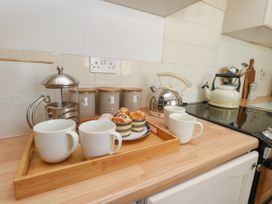 A kitchen with mugs and a coffee maker at 57 High Street in Portland