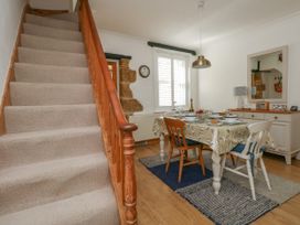 A dining room with a table set for a meal at 57 High Street in Portland