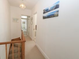 A hallway with a staircase and pictures on the wall at 57 High Street in Portland