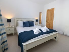 A bedroom with a bed and bedside table at 57 High Street in Portland