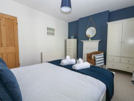 A bedroom with a bed and wardrobe at 57 High Street in Portland