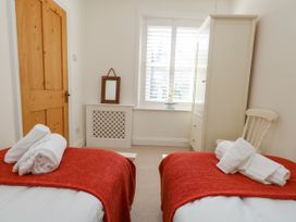 A bedroom with two beds and a wardrobe at 57 High Street, Portland