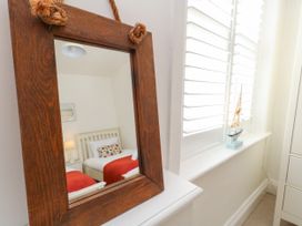 A bedroom with a bed and decorative items at 57 High Street in Portland