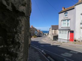 A street view with houses and the ocean in the distance at 57 High Street, Portland