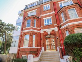 A building with a red brick facade and windows at The Pines in Bournemouth