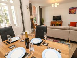 A dining room with a table set for dinner at The Pines Bournemouth