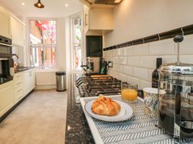 A kitchen with a stove and croissant on the countertop at The Pines in Bournemouth