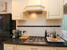 A kitchen with a stove and coffee machine at The Pines in Bournemouth