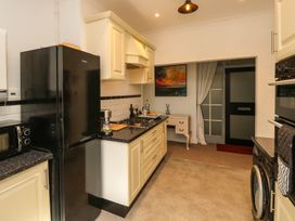 A kitchen with a refrigerator, stove, and sink at The Pines in Bournemouth