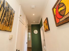 A hallway with wall art and a clock at The Pines in Bournemouth