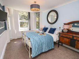 A bedroom with a bed and a dresser at The Pines in Bournemouth