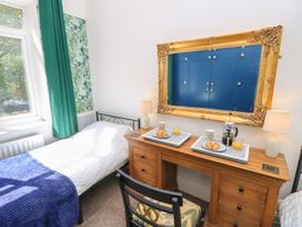 A bedroom with a bed and a table serving breakfast at The Pines in Bournemouth