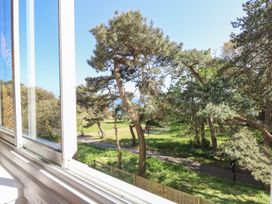 A view of trees and a path from a window at The Pines in Bournemouth