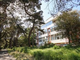 A building surrounded by trees and greenery at The Pines in Bournemouth