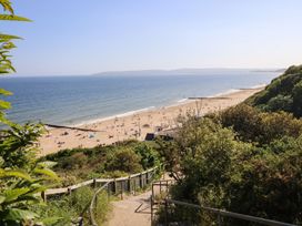 A view of the beach with people enjoying at The Pines in Bournemouth
