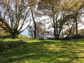 A landscape with trees and grass overlooking the ocean at The Pines in Bournemouth