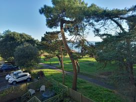 A view of trees and cars near the ocean at The Pines in Bournemouth