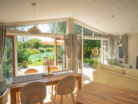A living room with a view of a river at Ash Lodge in Stowmarket