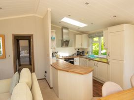 A kitchen with modern cabinets and appliances at Ash Lodge in Stowmarket