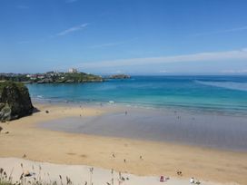 A beach with sand and people at Seaside Retreat in Newquay