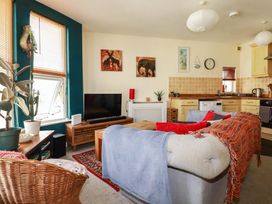 A living room with a sofa and television at Seaside Retreat in Newquay