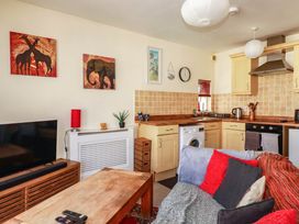 A living room with a sofa and tv at Seaside Retreat in Newquay
