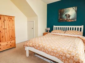 A bedroom with a bed and wardrobe at Seaside Retreat in Newquay