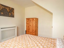 A bedroom with a bed and wardrobe at Seaside Retreat in Newquay