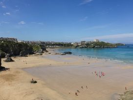 A beach scene with people and water at Seaside Retreat in Newquay