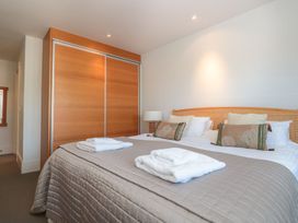 A bedroom with a bed and wardrobe at 33 Dart Marina in Dartmouth