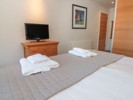 A bedroom with a bed and towels on top at 33 Dart Marina in Dartmouth